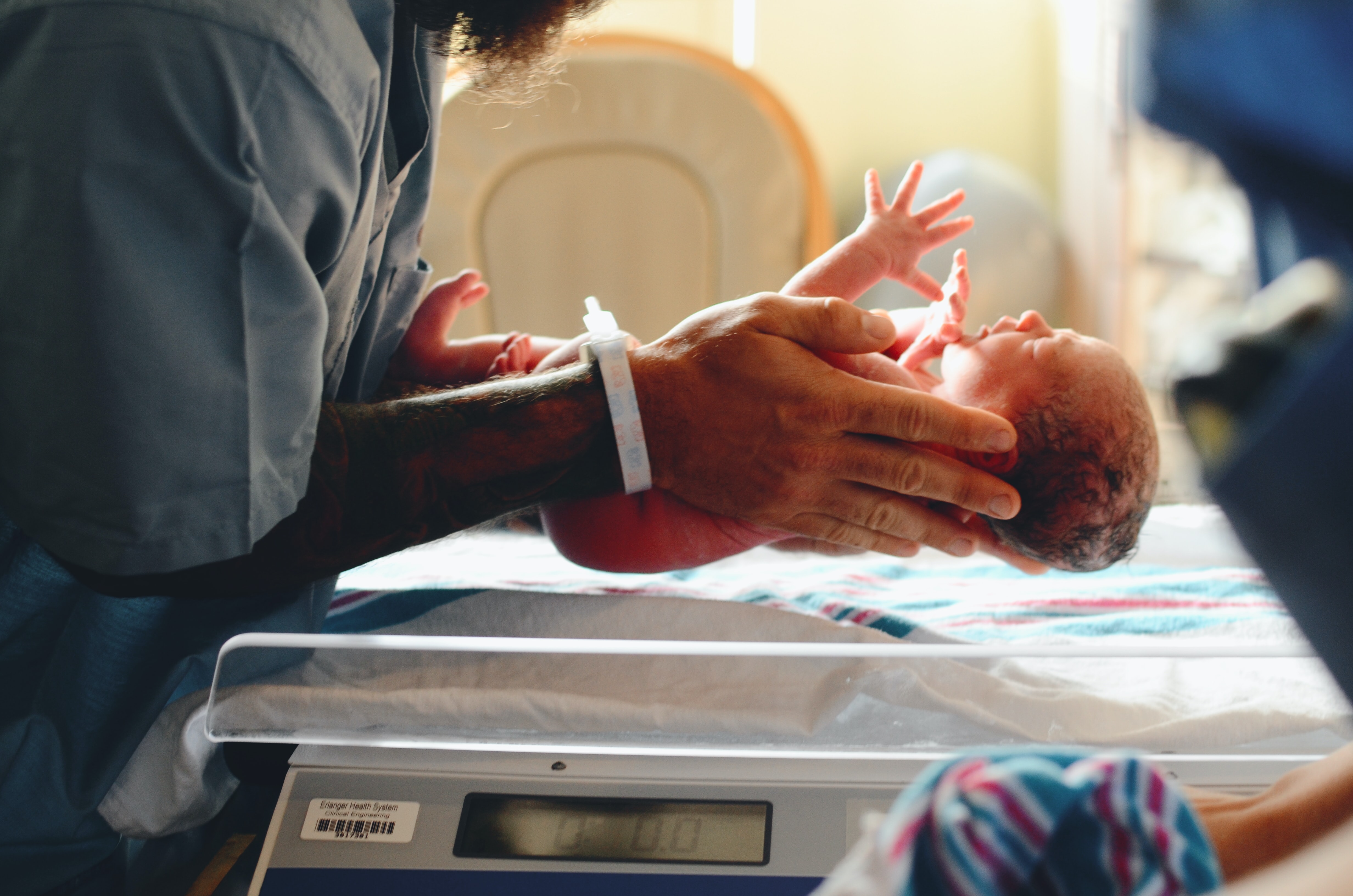 Big headed babies and a narrow pelvis mean Homo sapiens have a particularly difficult time giving birth A newborn baby being held by a person wearing scrubs in a hospital setting
